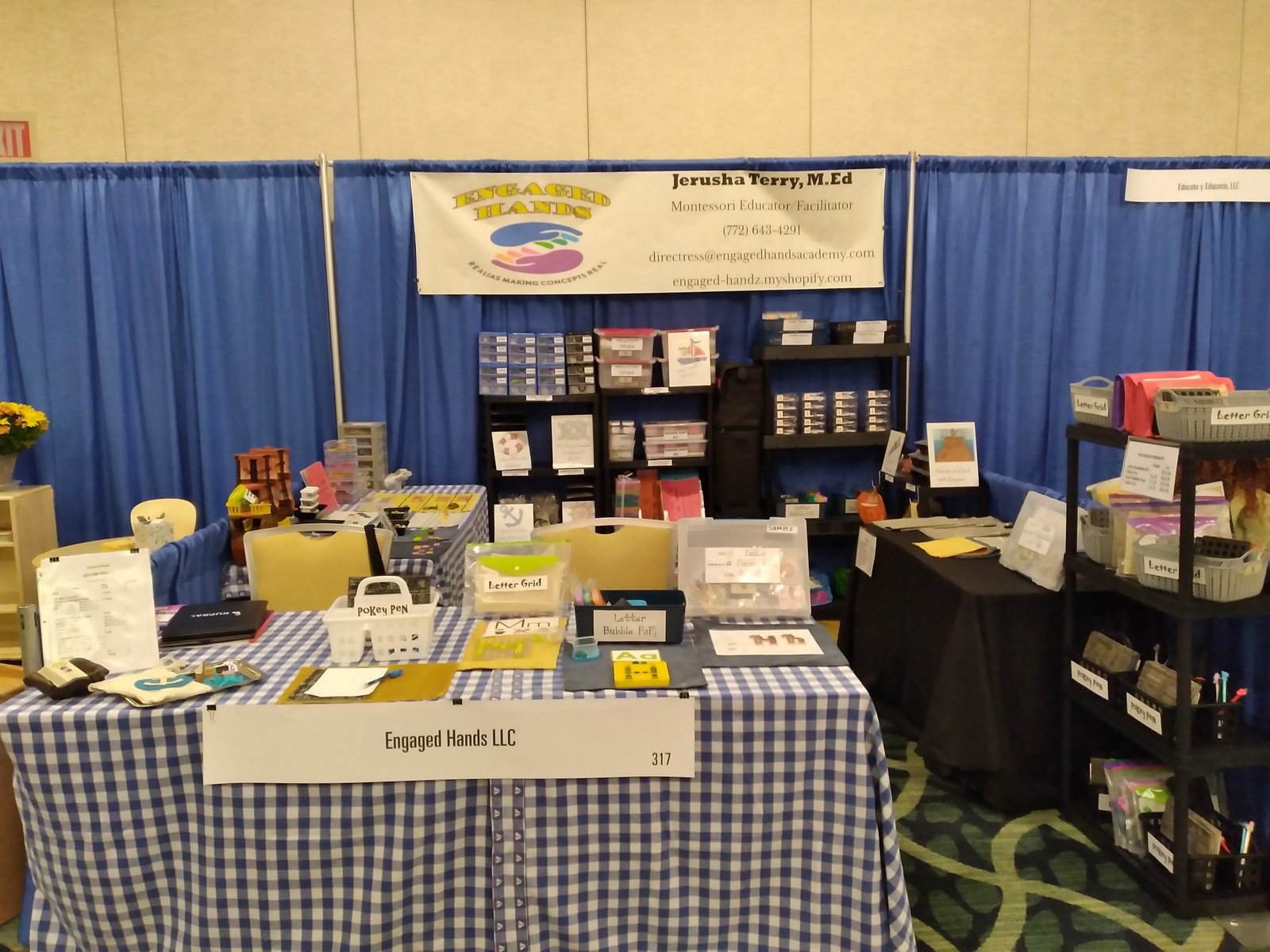 Engaged Hands learning materials booth display with baskets, cards, and hands-on educational tools