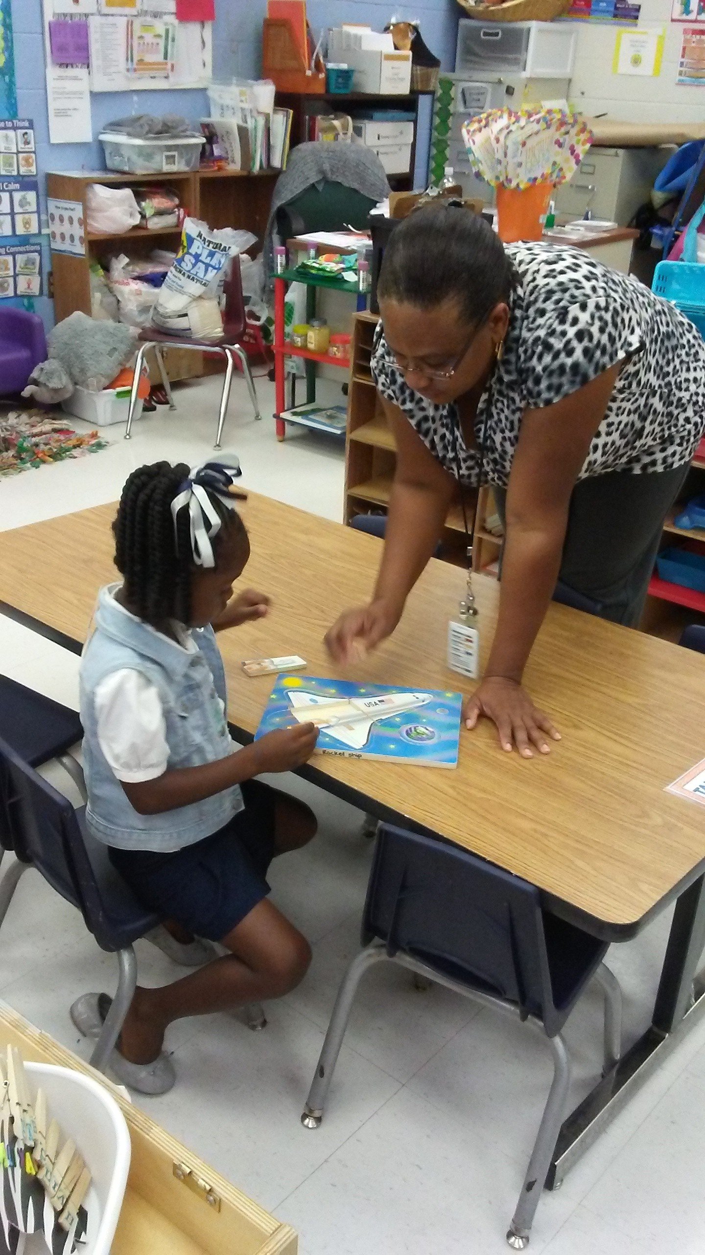 Children practicing literacy with hands-on letter manipulatives