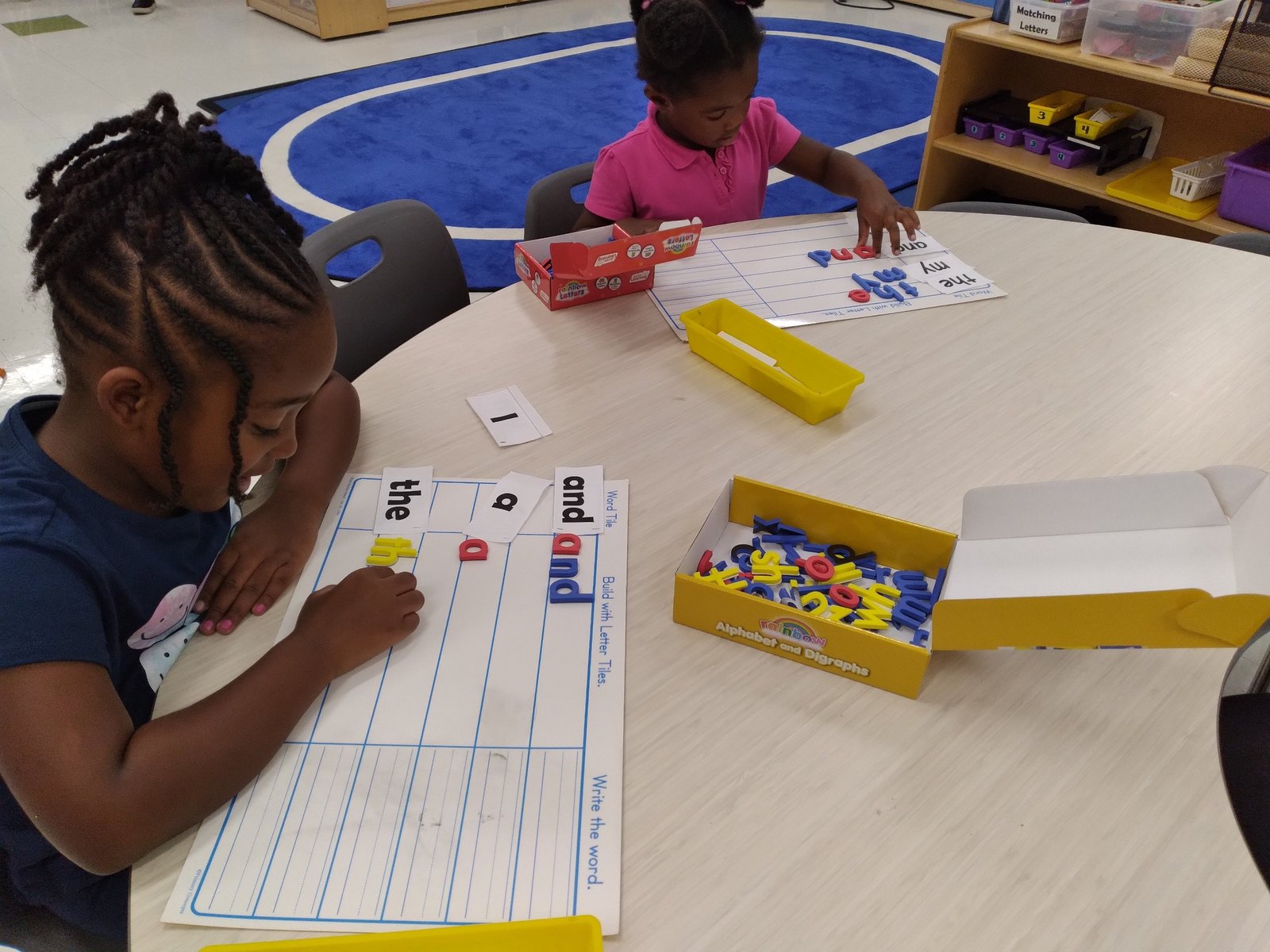 Toddlers exploring learning materials with guided support