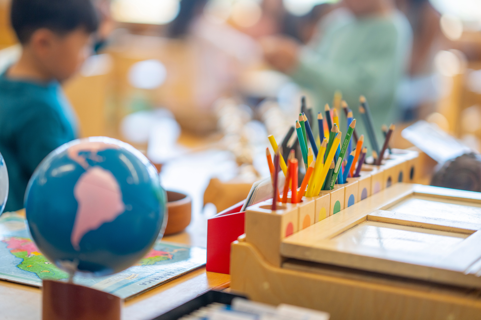 Globe, map, and Montessori learning materials in a classroom setting