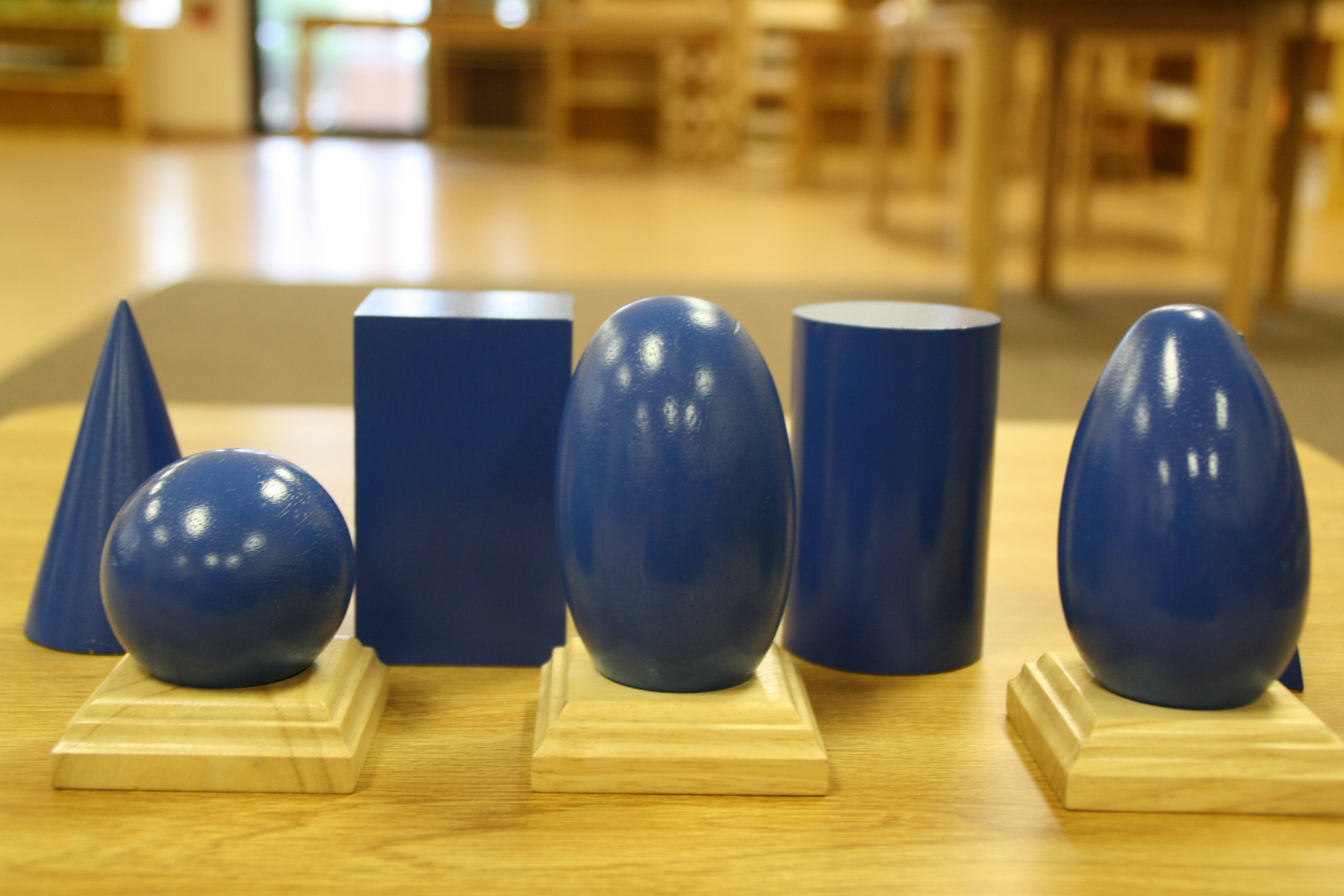 Montessori geometric solids on a classroom shelf