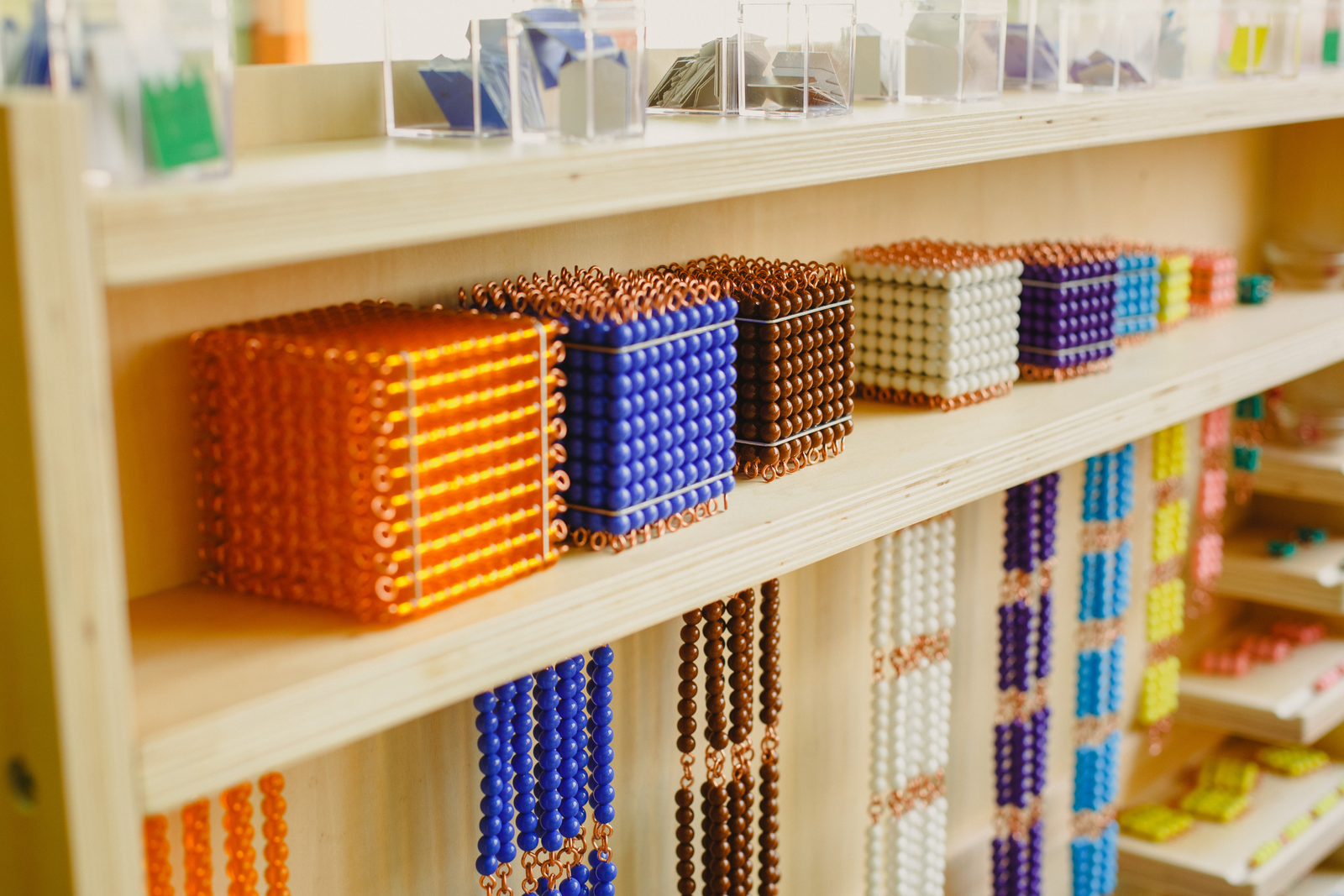 Montessori bead cabinet with colorful numeracy materials