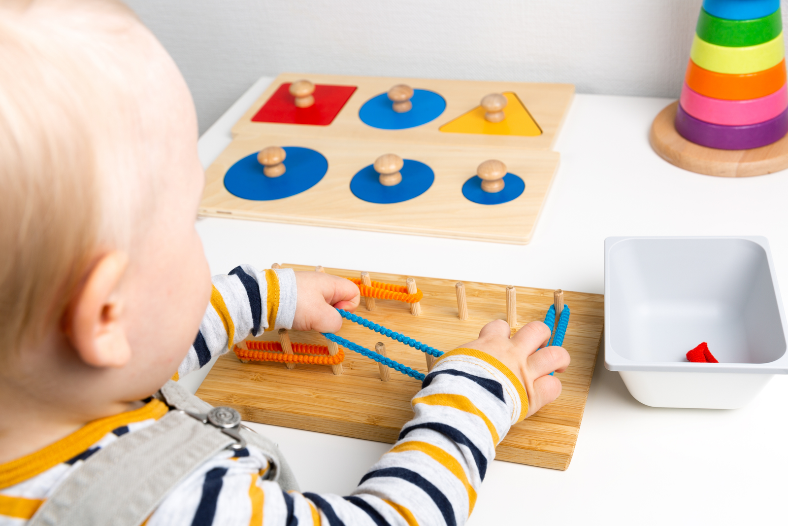 Child using a fine-motor rubber-band board