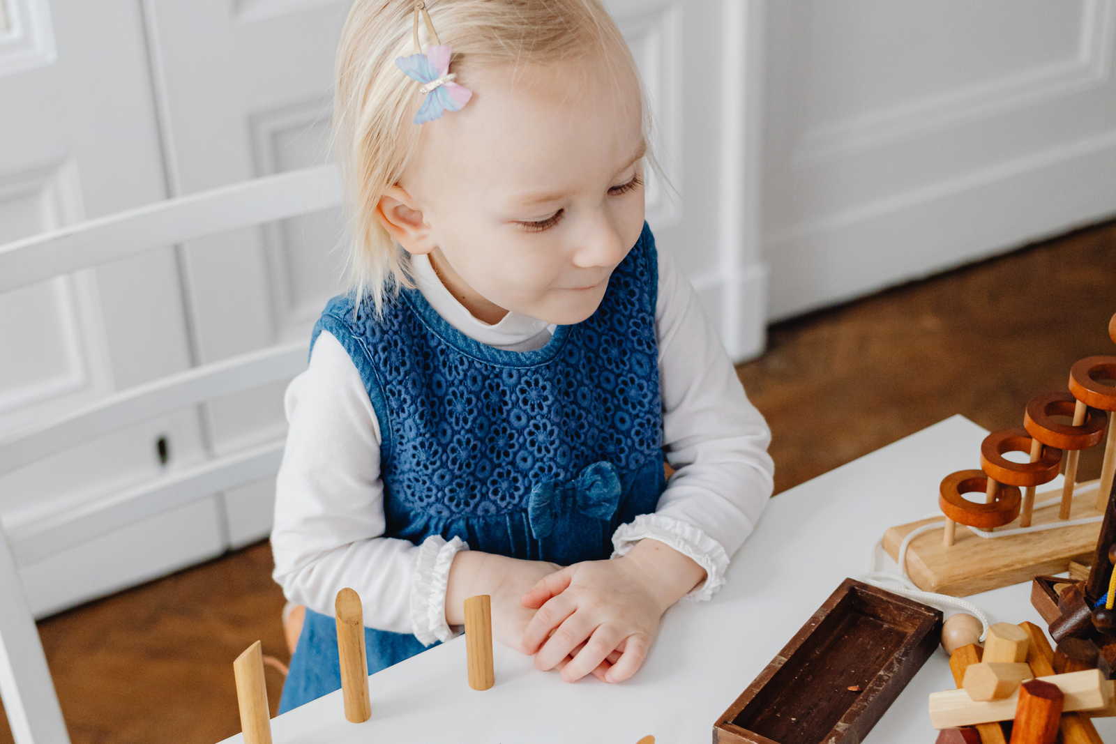 Focused child exploring Montessori counting materials at a table